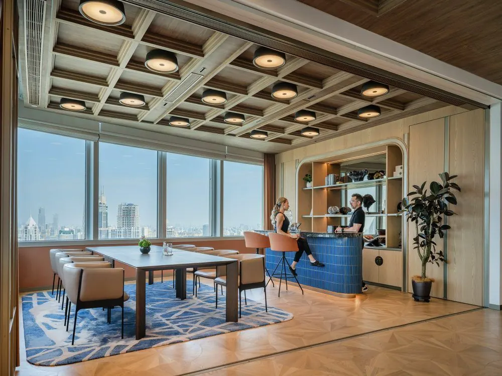 Lounge with a coffered ceiling and a view of the city skyline