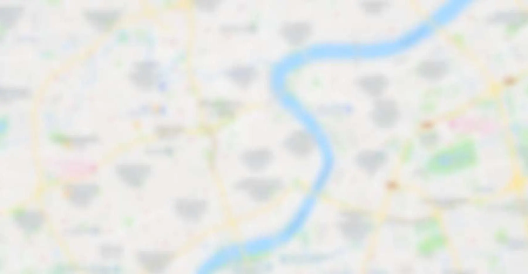 Blurred map showing city streets and a river