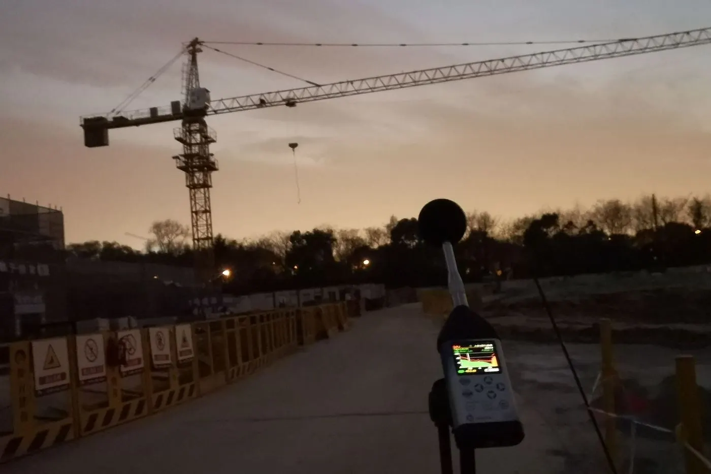 Sound level meter at a construction site at dusk