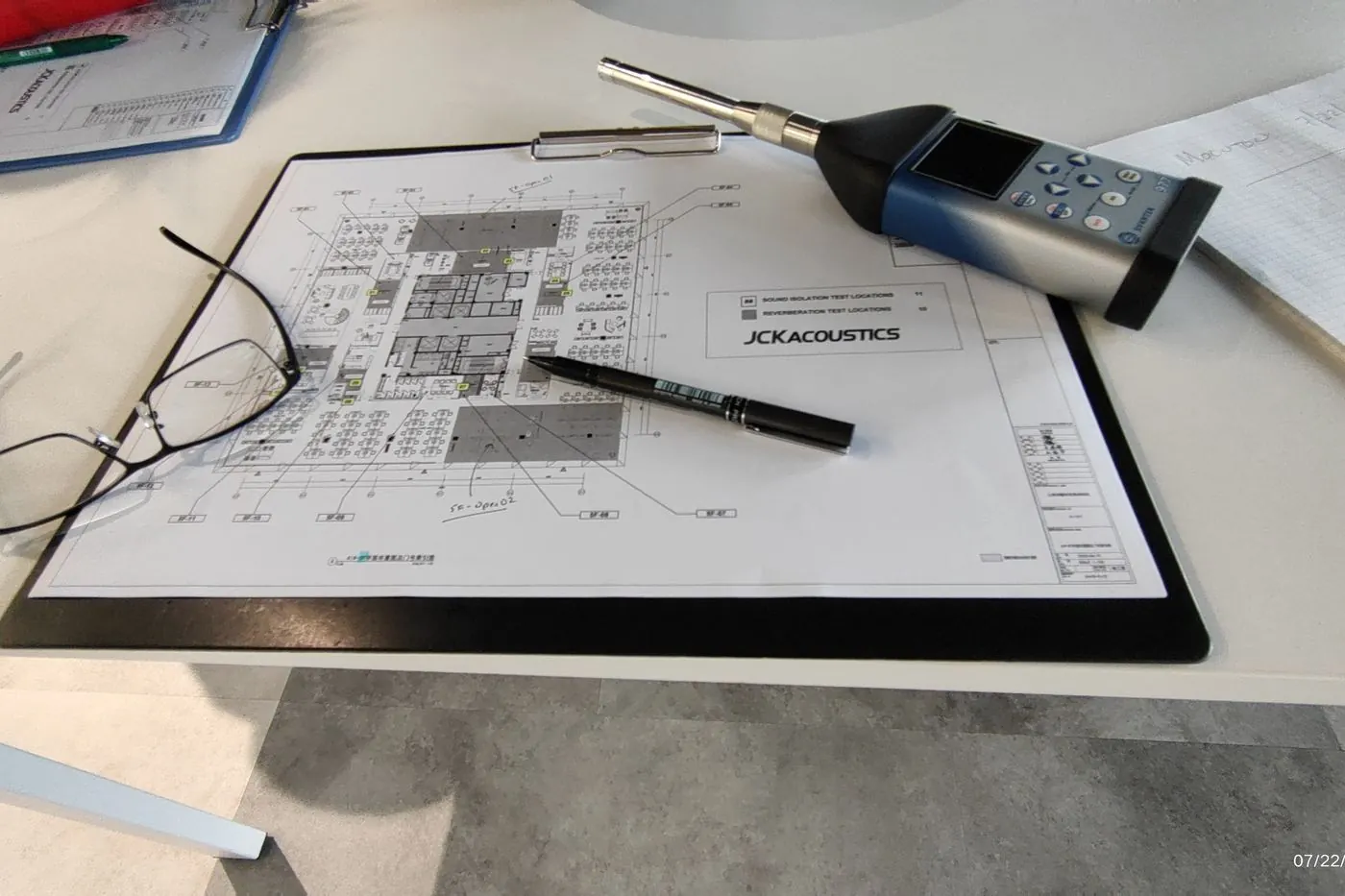 Acoustic drawings under review with a sound level meter